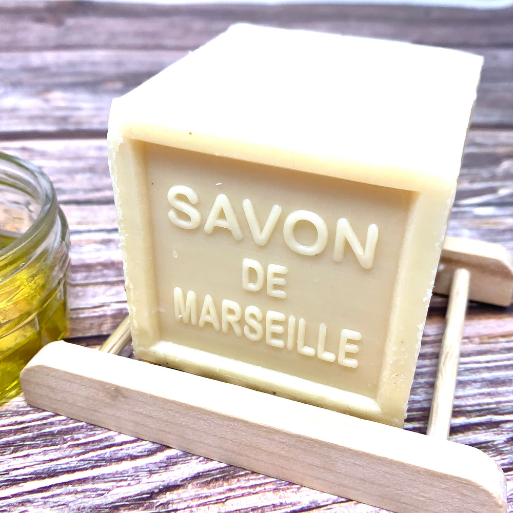 savon de marseille cube  made with natural ingredients on bamboo soap dish
