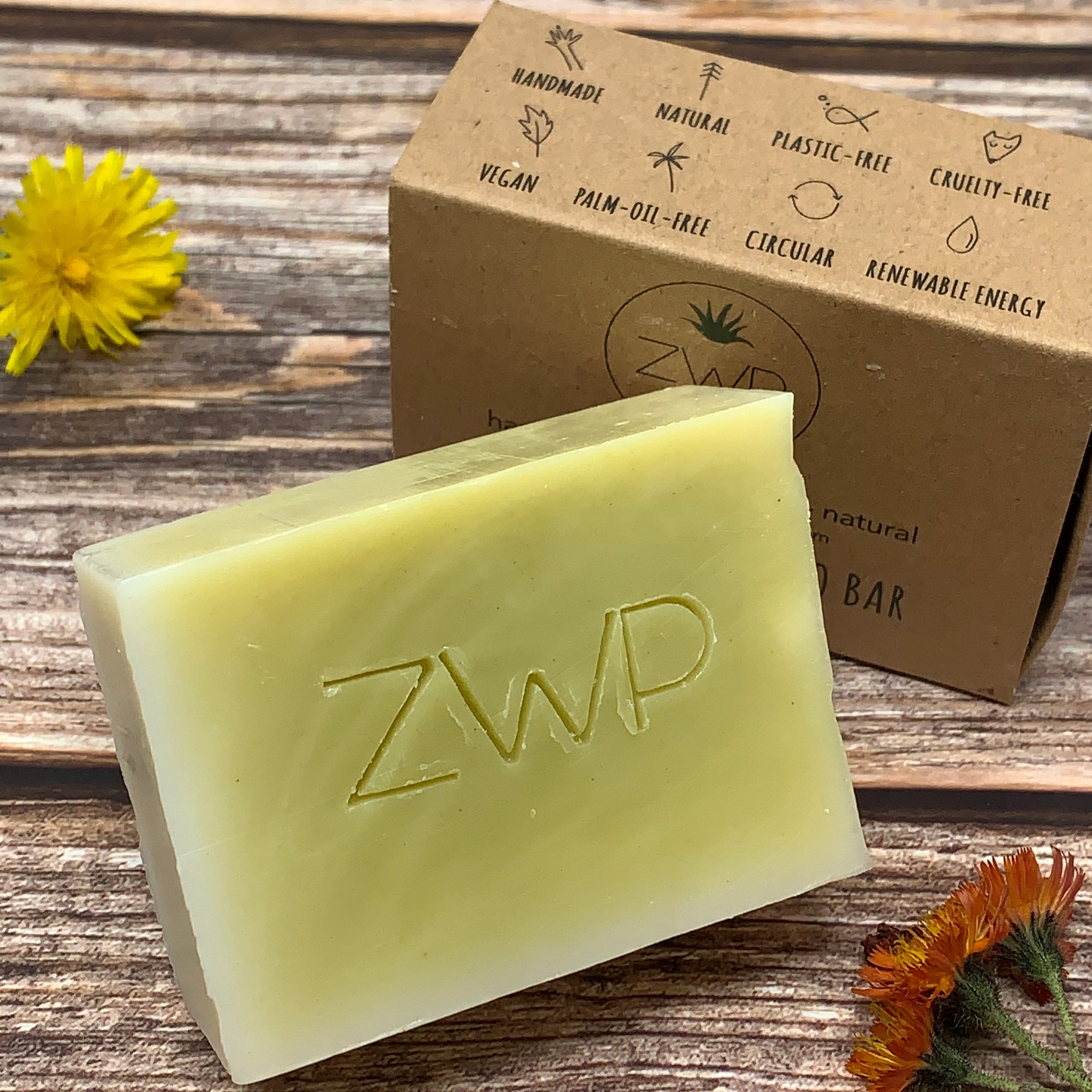 solid yellow shampoo bar with ZWP logo engraved  and brown box without plastic