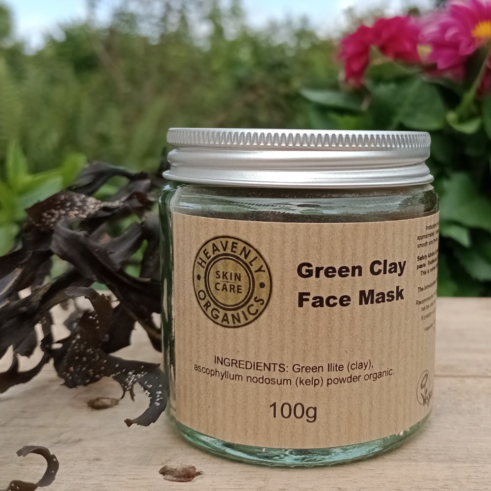 green clay face mask in a glass jar and metal cap by heavenly organics