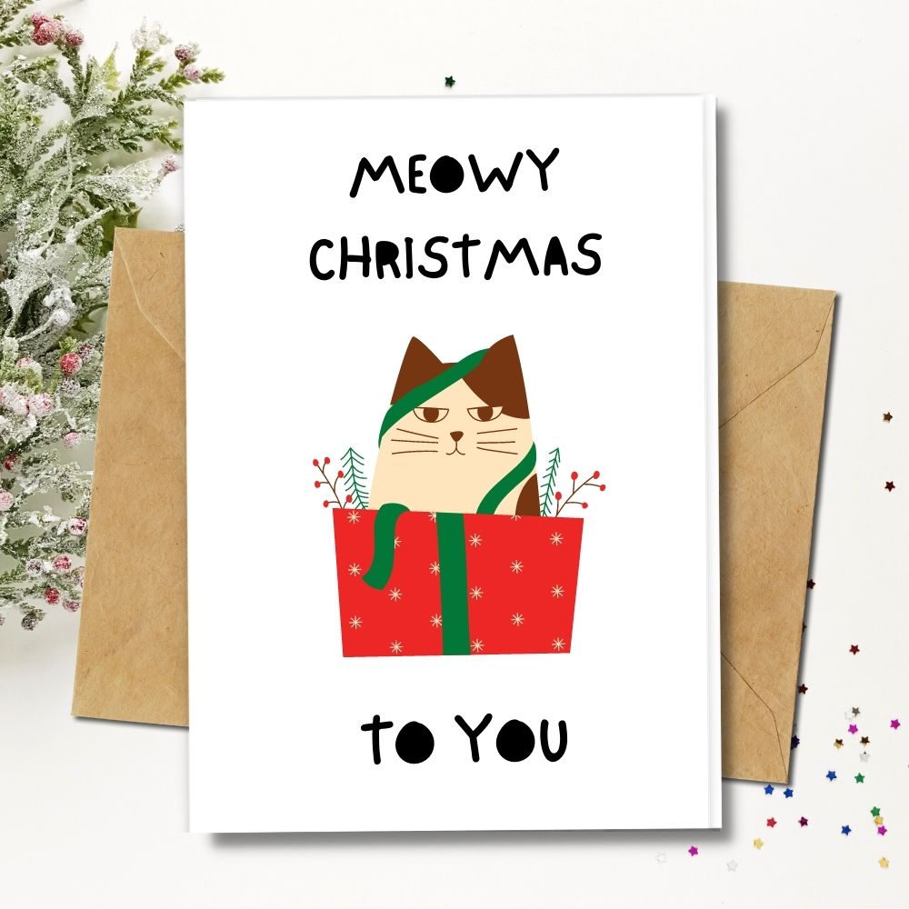 handmade christmas cards with cute cat in gift box greeting you a meowy Christmas