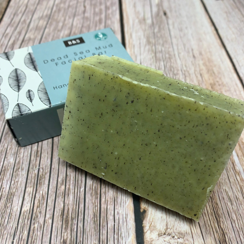 green dead sea mud facial soap bar with black small spots on surface