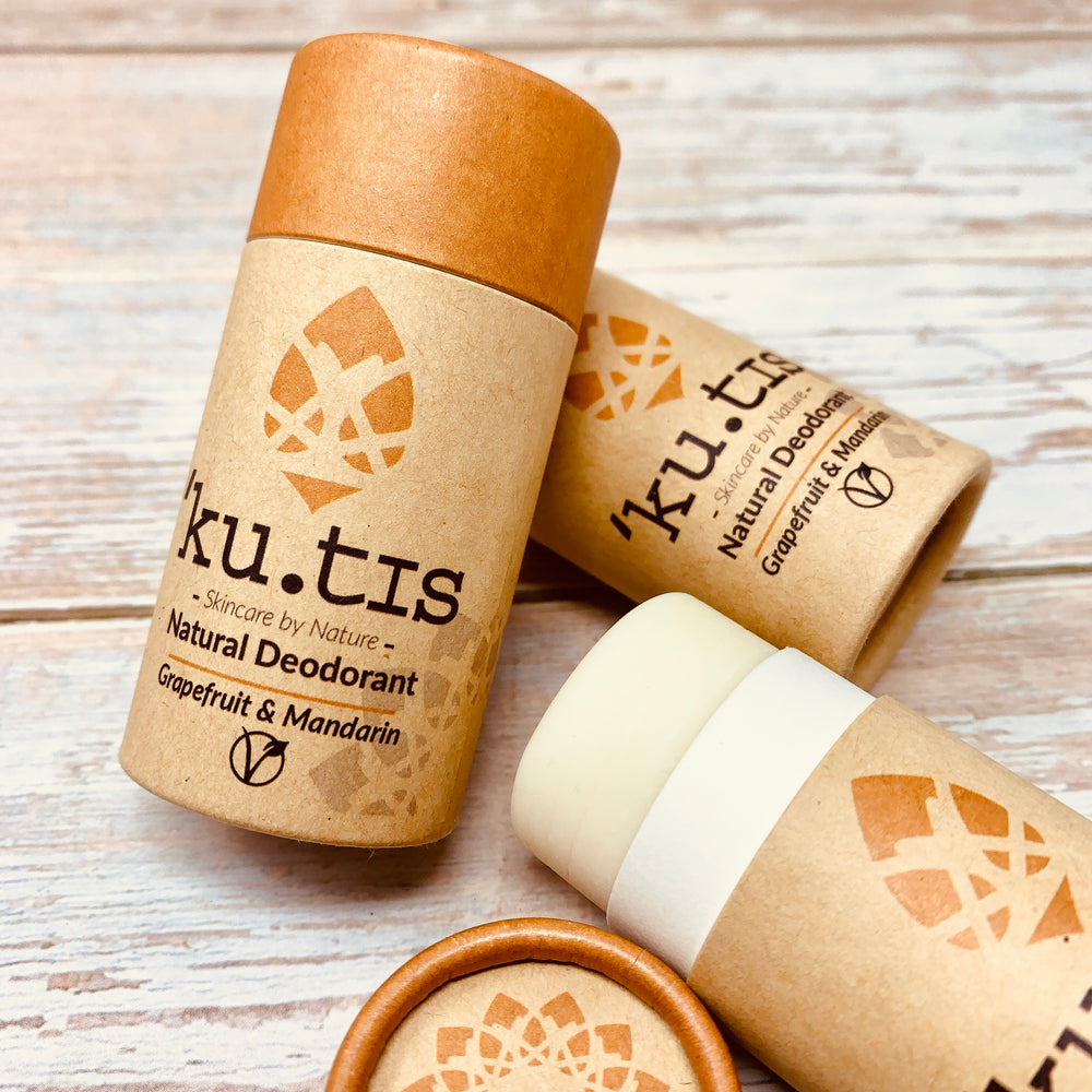 vegan deodorant packed in recyclable cardboard packaging by kutis on a wooden background