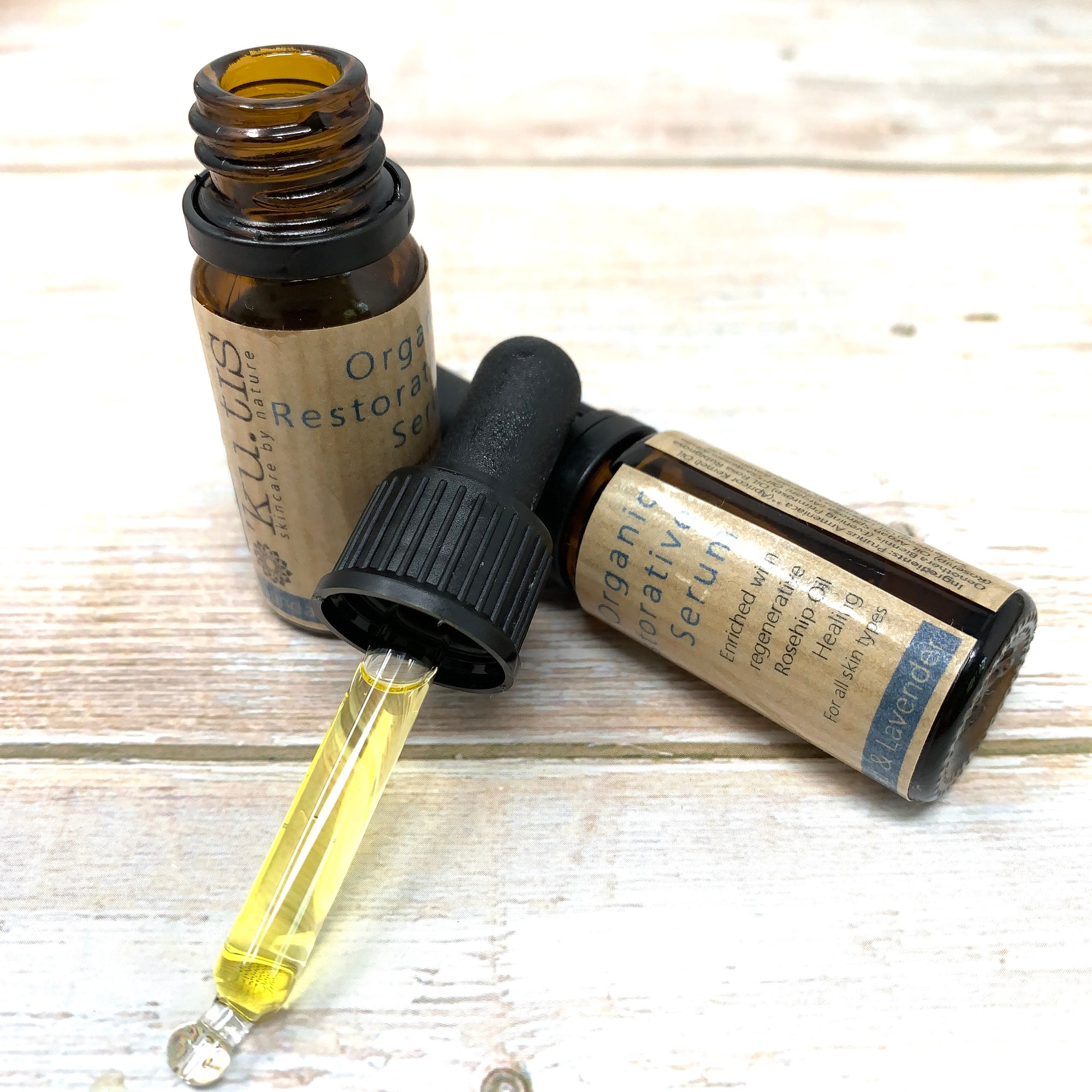 sandalwood and lavender restorative face serum by kutis in glass bottles
