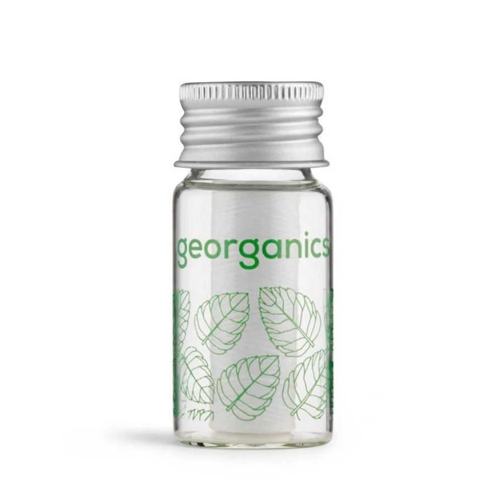 georganics spearmint floss in glass jar and mental cap
